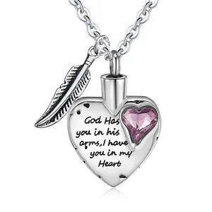 Heart-shaped cremation urn necklace featuring a feather charm and purple crystal stone.