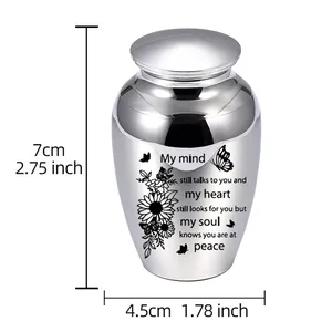 Small polished silver cremation urn with engraved memorial poem and butterflies