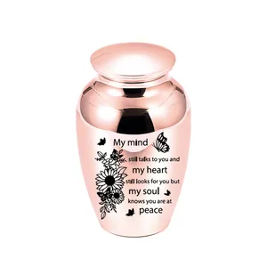 Small rose gold aluminum cremation urn with engraved memorial quote and sunflower design