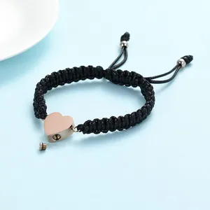 Handmade black woven rope bracelet with rose gold stainless steel heart cremation urn pendant