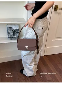 Brown nylon underarm bag with metal lock clasp and small card holder detail