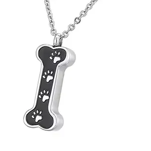 Close-up of stainless steel bone cremation pendant with paw prints for pet ashes