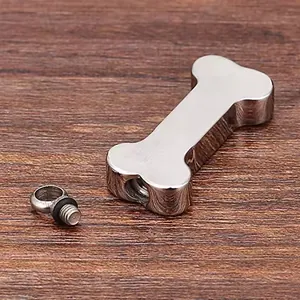 Macro view of the screw-in top detail for a bone-shaped stainless steel urn pendant.
