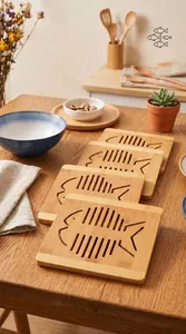 Detail view of hollow fish-shaped bamboo heat insulation mats on a wooden table