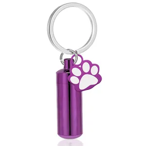 Purple cylindrical pet cremation urn keychain with a cute paw print charm detail.