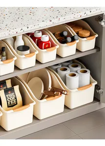 Detail showing multi-purpose beige kitchen storage bins organized inside a cabinet shelf