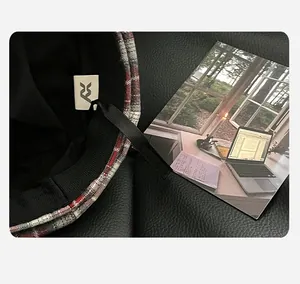Detailed view showing the plaid beret hat interior sweatband and brand logo label