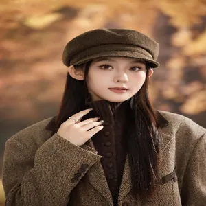 Close-up of a brown wool newsboy cap worn by a model in a vintage British style