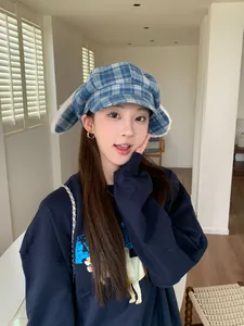 Detailed view of the blue plaid octagonal hat featuring cute plush rabbit ears