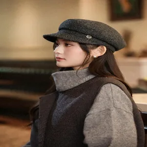 Elegant side profile detail of a vintage charcoal grey wool newsboy hat for women