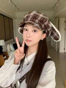 Asian model wearing a stylish brown plaid newsboy hat with cute plush rabbit ears