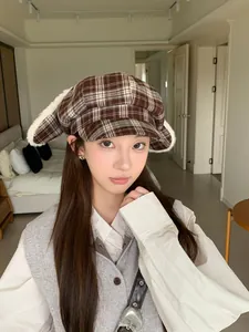 Model wearing sweet plaid octagonal hat with cute plush bunny ears for winter fashion