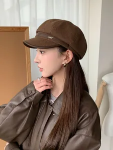 Vintage brown wool newsboy hat with short leather brim detail worn by an Asian model