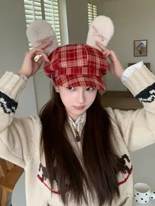 Detailed view of red plaid octagonal hat featuring cute plush bunny ears and bows