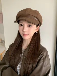 Stylish brown wool newsboy hat featuring a faux leather brim worn by an Asian woman
