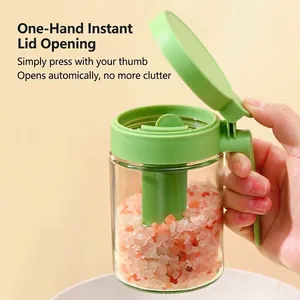 Green glass seasoning jar with one-handed lid for salt and spice storage in kitchen