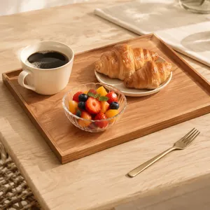 Rectangular wooden breakfast tray with natural grain holding coffee and pastries