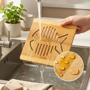 Fish-shaped bamboo trivet being washed under water with a close-up of water resistance.