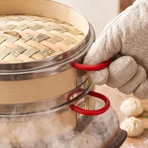 Two-tier stainless steel bamboo steamer basket for dumplings and buns in kitchen setting
