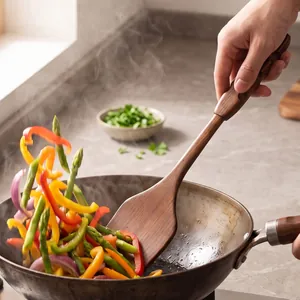 Large vintage wooden kitchen spatula for stir-frying fresh vegetables in a wok