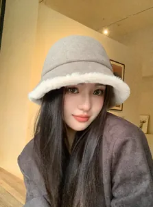 Close-up of a stylish women's wool bucket hat with soft faux fur trim for winter