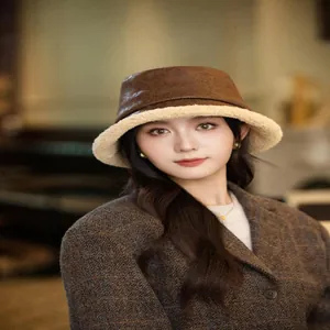 Chic vintage brown suede bucket hat with warm faux shearling lining for winter fashion