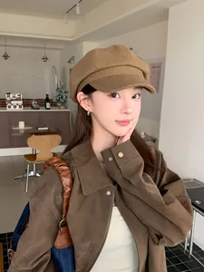 Close-up of a stylish brown wool newsboy hat for women in a vintage cafe setting.