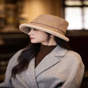 Close-up of a vintage suede bucket hat with warm fleece lining worn by model