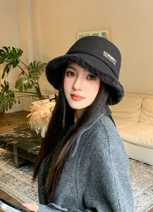 Close-up of stylish black wool bucket hat featuring a furry brim and horsebit metal detail