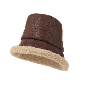 Close-up of retro suede fisherman hat with plush faux lamb wool trim for winter warmth.