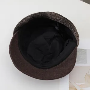 Detailed view of the soft black inner lining and adjustable strap of a wool newsboy cap