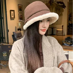 Elegant women's brown wool bucket hat with stylish white plush brim for winter warmth