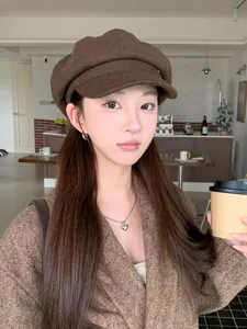Detailed texture of a retro brown wool baker boy hat styled with a chic autumn outfit