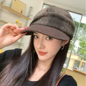 Retro brown checkered newsboy hat for women, wool-like baker boy cap in a cafe setting