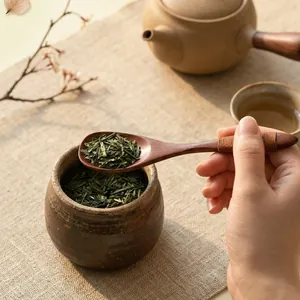 Small handmade wooden spoon with thread wrapping for tea, honey, or coffee stirring