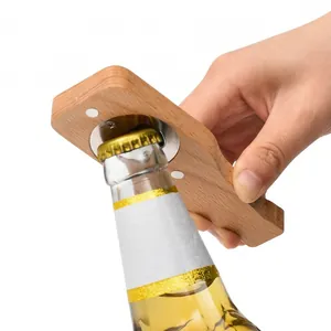 Ergonomic magnetic beech wood beer bottle opener being used to open a glass bottle.
