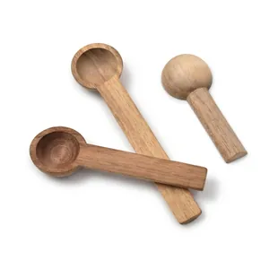 Set of three natural acacia wood seasoning spoons for coffee, honey, and jam on white background.