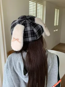 Detailed back view of a plaid octagonal hat with cute plush rabbit ears and bows