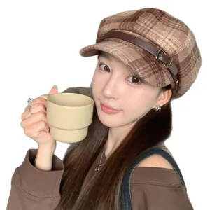 Classic retro plaid newsboy cap with leather buckle detail worn by an Asian model