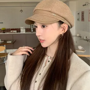Elegant khaki woolen baker boy hat with leather trim for women in a cafe setting