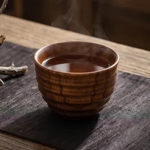 Hand-carved jujube wood teacup with ridged texture and natural grain