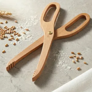 Beechwood scissors-style bread tongs for serving food and pastries on stone surface