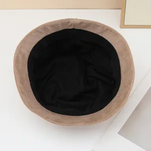 Detailed interior view of a khaki suede-style bucket hat with soft black lining.