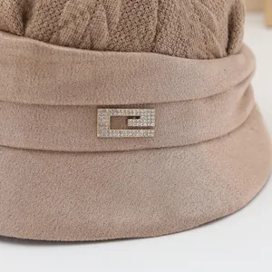 Close-up of sparkling rhinestone buckle on brown knitted fisherman hat for winter
