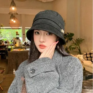 Elegant Korean style black bucket hat for women with sun protection and pleat detail.