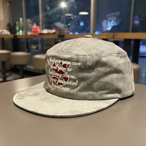 Distressed gray flat brim cadet cap featuring red S embroidery and inspirational quote