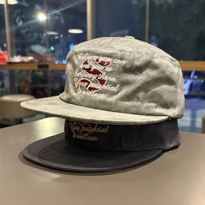 Two flat brim baseball caps with inspirational embroidered quote and stylized red S logo