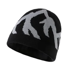 Fashionable black knit beanie with grey mountain jacquard pattern for winter warmth.