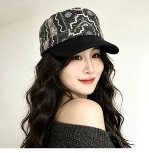 Detailed view of a vintage black cadet cap with intricate white embroidery and flat brim