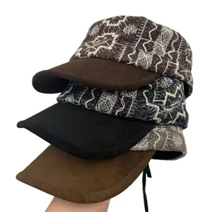Vintage embroidered flat newsboy caps with suede brims shown in a stacked arrangement